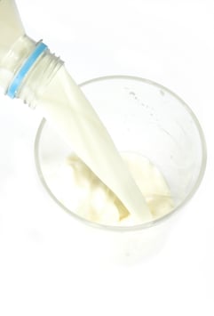 glass of milk being poured